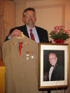 Wilfred O. Hansen Jr proudly shown with his fathers uniform. 